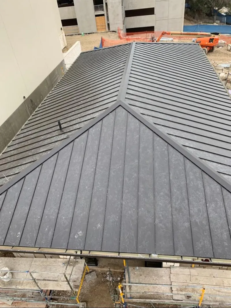 Commercial metal roof construction with crane equipment in Waikoloa Village